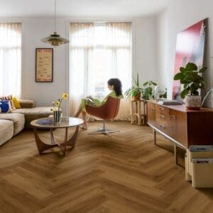 Living room with Quick-Step Alpha Ciro Botanic Caramel Oak herringbone pattern luxury vinyl flooring featuring modern furniture and decor