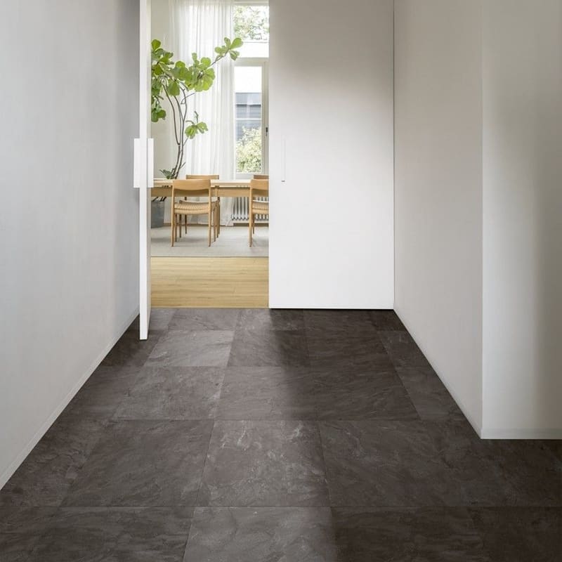 Entryway with dark slate tiles transitioning to honey oak laminate flooring