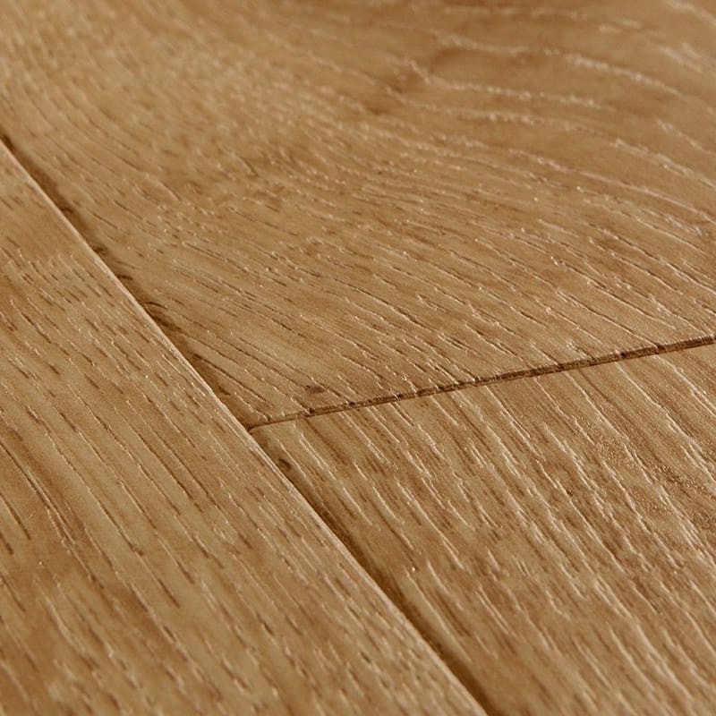 Close-up detail of Quick-Step Impressive Classic Oak Natural laminate flooring showing beveled edge