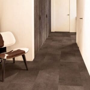 Quick-Step Alpha Oro Cinnamon Rock vinyl flooring installed in a modern hallway with white walls