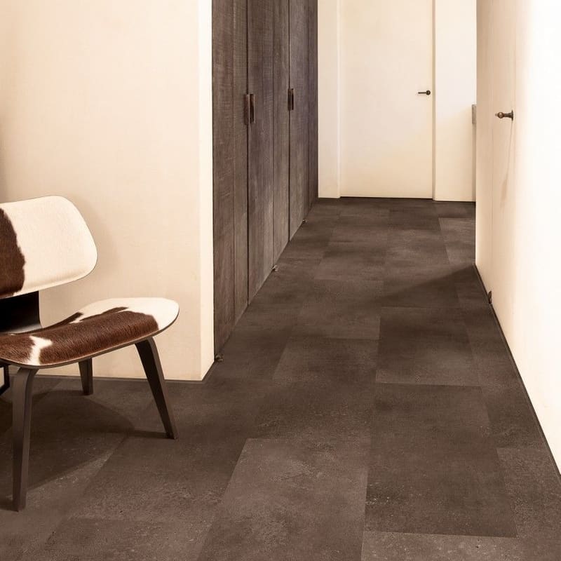 Quick-Step Alpha Oro Cinnamon Rock vinyl flooring installed in a modern hallway with white walls