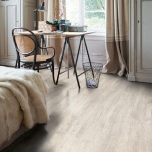 Detailed view of Quick-Step Classic Reclaimed White Patina Oak CL1653 laminate flooring showing plank joints and surface texture