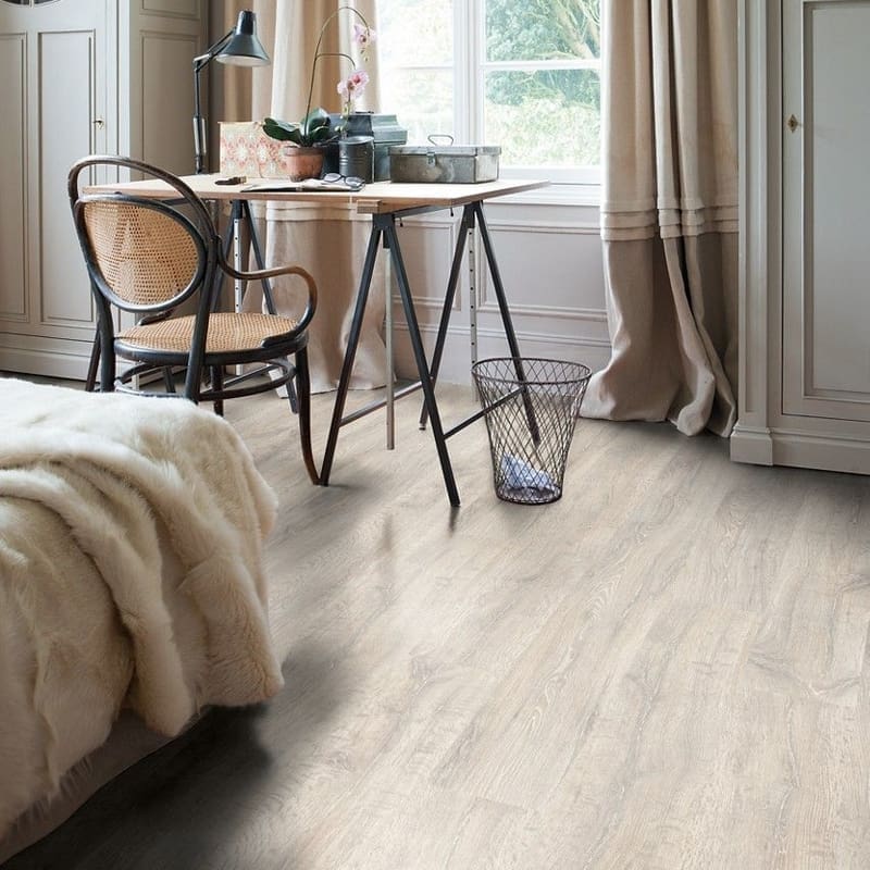 Detailed view of Quick-Step Classic Reclaimed White Patina Oak CL1653 laminate flooring showing plank joints and surface texture
