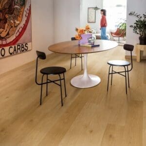 Dining room featuring Quick-Step Alpha Blos Coast Oak Honey vinyl flooring with contemporary furniture