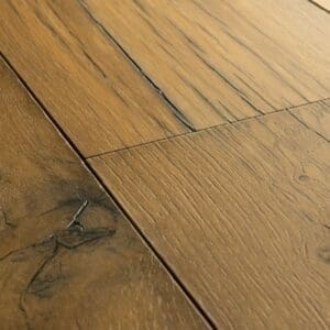 Kitchen with green cabinetry and Quick-Step Capture Cracked Oak Natural Laminate flooring