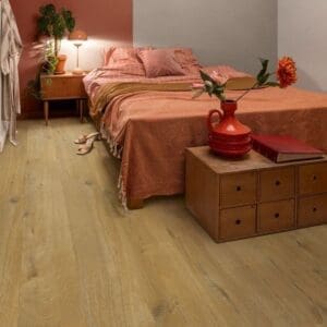 Bedroom with Cotton Oak Deep Natural flooring featuring terracotta accent wall
