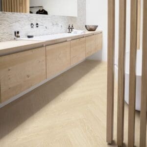 Contemporary bathroom with floating vanity and Quick-Step Alpha Ciro Pure Oak Polar flooring in herringbone pattern