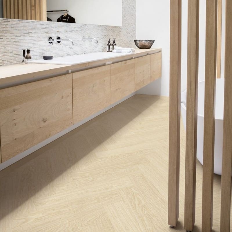 Contemporary bathroom with floating vanity and Quick-Step Alpha Ciro Pure Oak Polar flooring in herringbone pattern