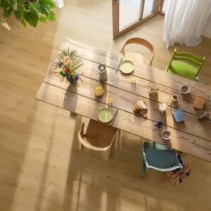 Modern living room with leather sofa and Quick-Step Alpha Bloom Brushed Oak Honey vinyl flooring