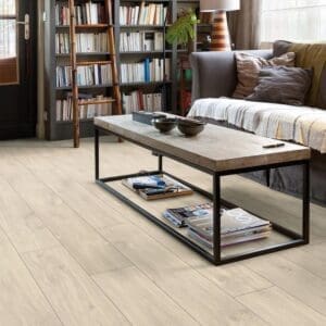 Modern living room with bookshelf featuring Quick-Step Havana Oak Natural flooring