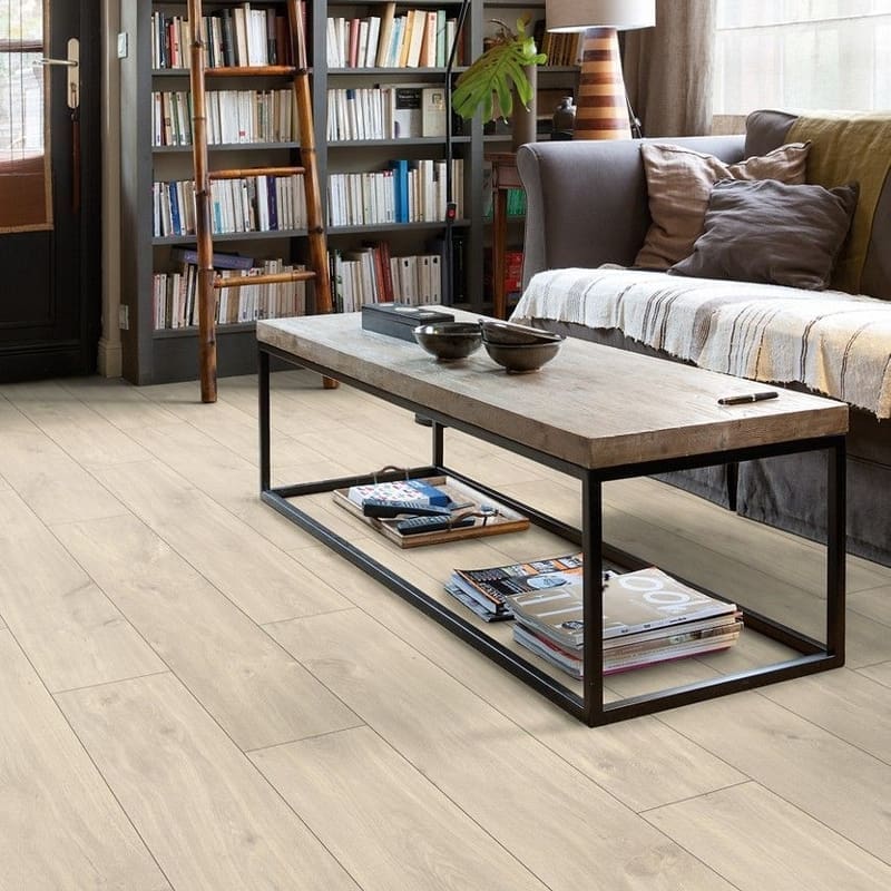 Modern living room with bookshelf featuring Quick-Step Havana Oak Natural flooring