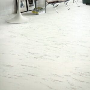 Contemporary living space with Quick-Step Alpha Oro Marble Carrara White vinyl flooring, showcasing its elegant appearance with designer furniture