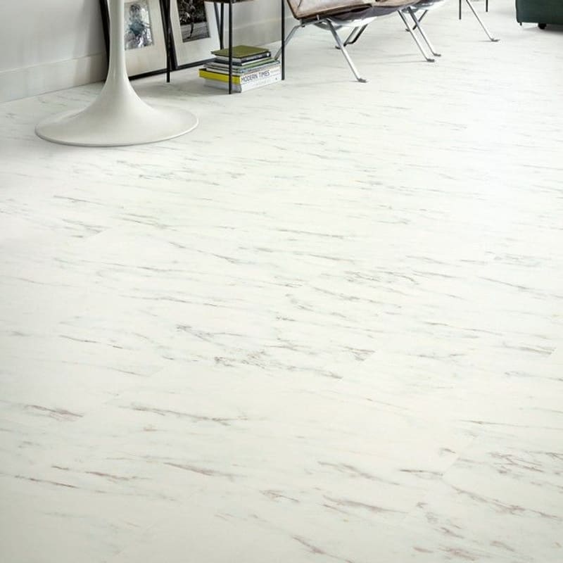 Contemporary living space with Quick-Step Alpha Oro Marble Carrara White vinyl flooring, showcasing its elegant appearance with designer furniture