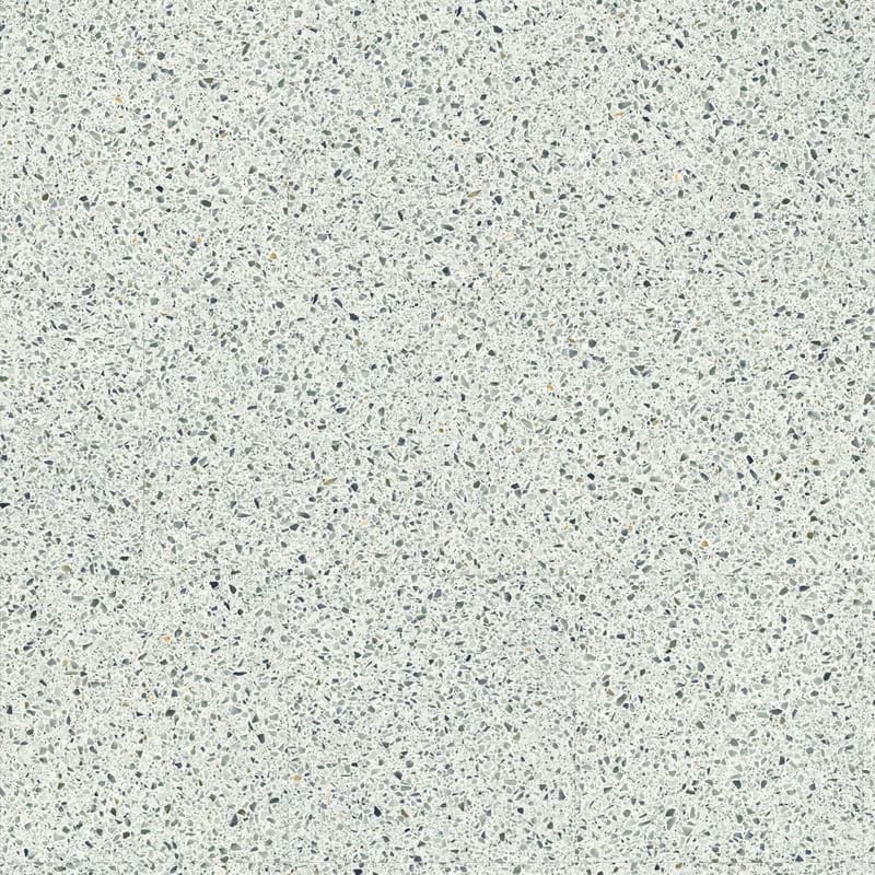 Moduleo Roots Lugano Terrazzo Effect luxury vinyl tile featuring a light base with scattered grey, blue and amber flecks in a classic terrazzo pattern