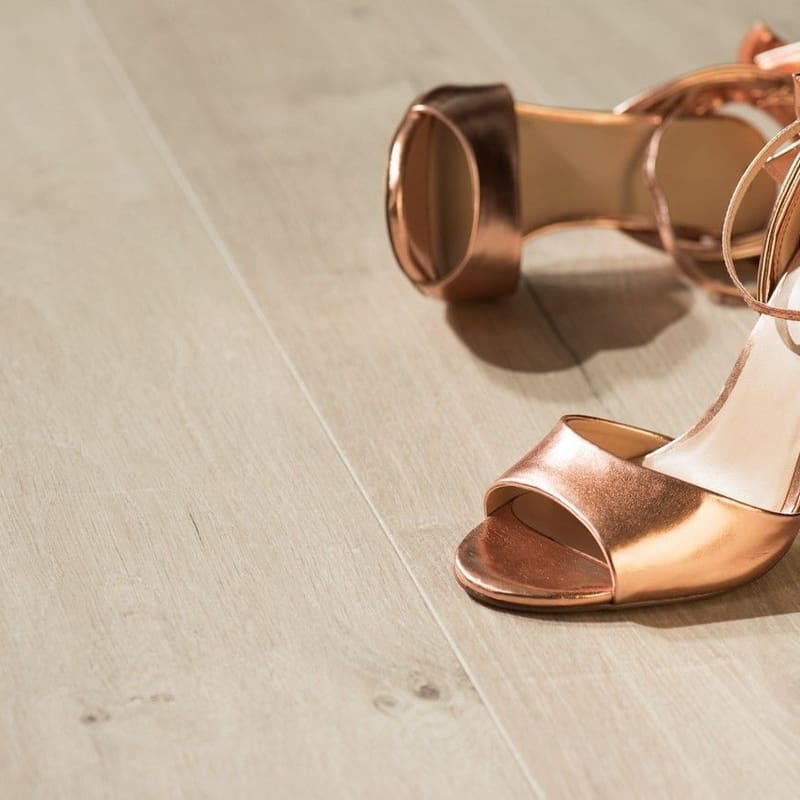 Rose gold high heels on Quick-Step Impressive Soft Oak Light laminate flooring showing the warm light oak tone