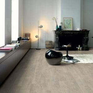 Living room with Quick-Step Classic Old Oak Light Grey laminate flooring, featuring modern furniture and fireplace