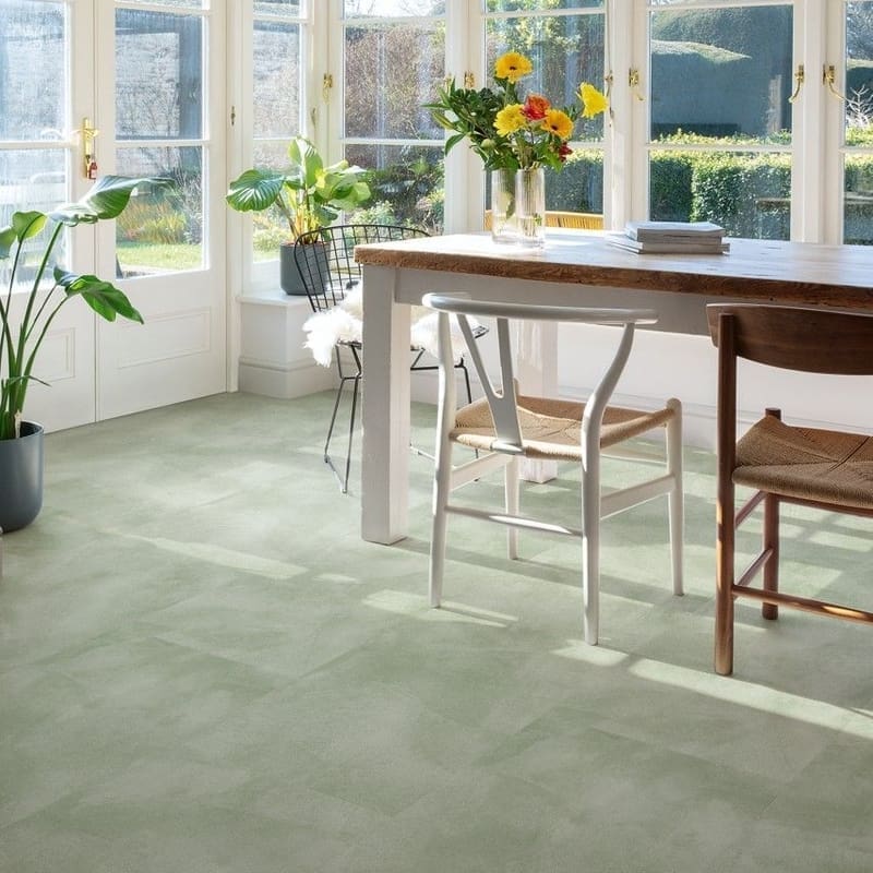 Close-up of Quick-Step Alpha Illume Soft Sage vinyl flooring showing detailed stone-effect texture