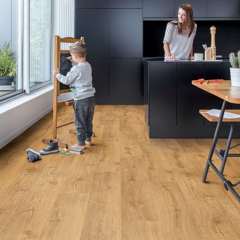 Modern kitchen with black cabinetry featuring Quick-Step Alpha Bloom Honey Oak vinyl flooring