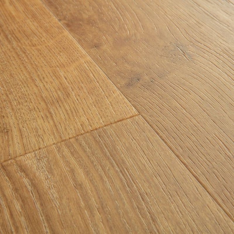 Close-up of Quick-Step Alpha Bloom Honey Oak vinyl flooring showing natural wood grain pattern and embossed texture