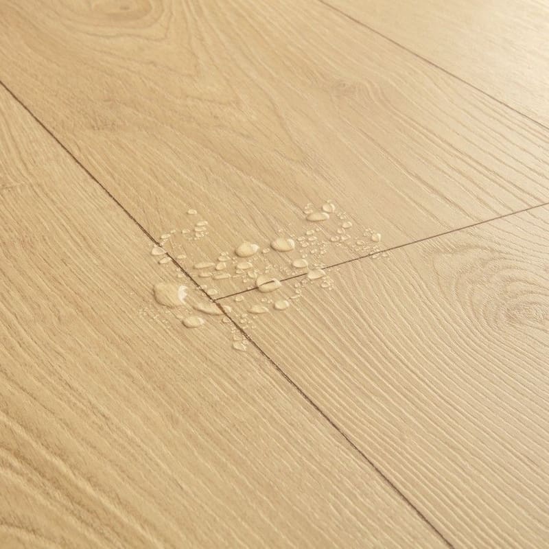Close-up of Quick-Step Desert Greige Oak laminate flooring showing natural oak grain pattern