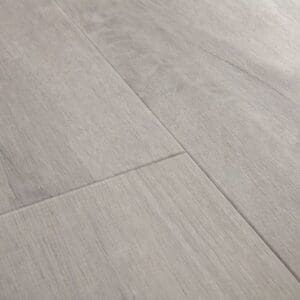 Close-up of Quick-Step Alpha Bloom Cotton Oak Cold Grey flooring showing light grey wood grain texture and plank joints