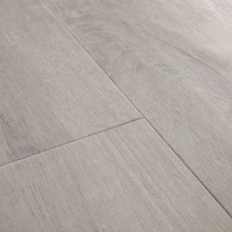 Close-up of Quick-Step Alpha Bloom Cotton Oak Cold Grey flooring showing light grey wood grain texture and plank joints