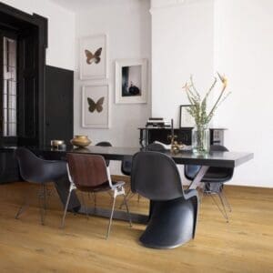 Quick-Step Alpha Bloom Cotton Oak Deep Natural vinyl flooring sample showing warm oak grain pattern