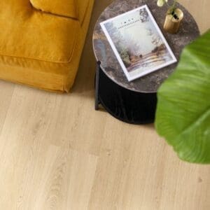 Person cleaning Quick-Step Botanic Beige flooring showing easy maintenance