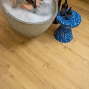 Kitchen island with child on stool on Quick-Step Alpha Bloom Brushed Oak Honey vinyl flooring