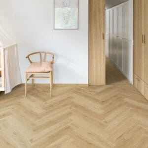 Quick-Step Alpha Ciro Botanic Beige Herringbone flooring in minimalist bedroom with wooden chair