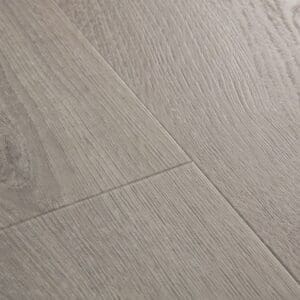 Close-up of Quick-Step Alpha Bloom Botanic Grey vinyl flooring showing wood grain texture and embossed finish
