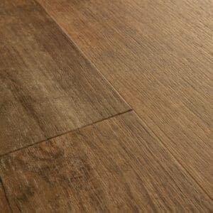 Close-up of Quick-Step Alpha Bloom Sundown Pine vinyl flooring showing texture and plank joints