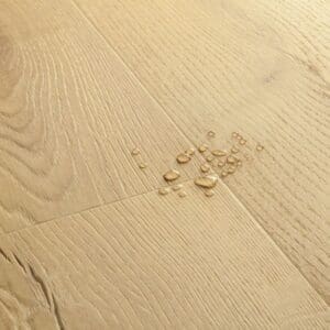 Cat sleeping on chair with Quick-Step Brushed Oak Beige flooring