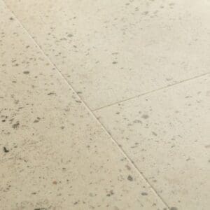Close-up of Quick-Step Pebble Concrete flooring showing terrazzo pattern and texture