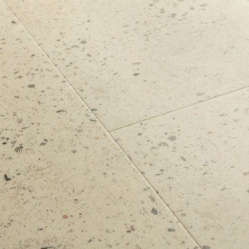 Close-up of Quick-Step Pebble Concrete flooring showing terrazzo pattern and texture