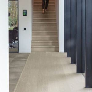 Modern interior hallway with Quick-Step Alpha Blos Chia Oak flooring and staircase