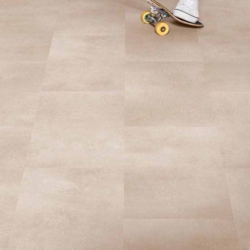Person skateboarding on Quick-Step Alpha Oro Coral Rock vinyl flooring showing durability