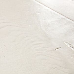 Detailed view of white laminate flooring showing natural wood grain pattern