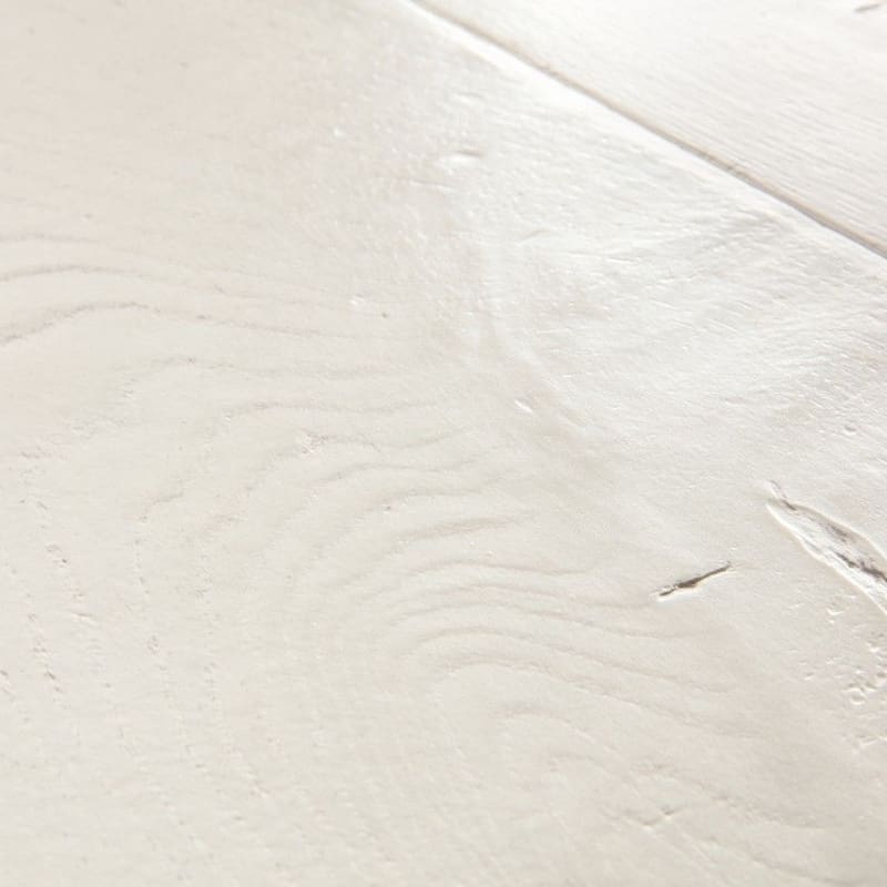 Detailed view of white laminate flooring showing natural wood grain pattern