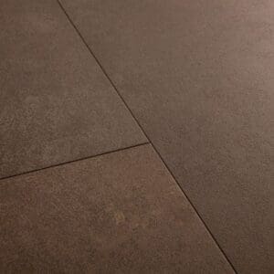 Close-up detail of Quick-Step Alpha Oro Cinnamon Rock vinyl flooring showing stone texture and tile joints