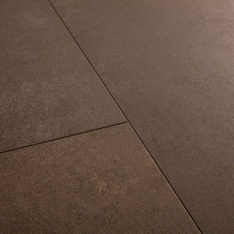 Close-up detail of Quick-Step Alpha Oro Cinnamon Rock vinyl flooring showing stone texture and tile joints
