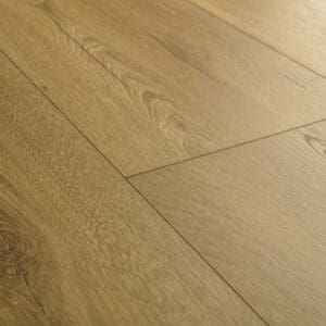 Close-up detail of honey oak laminate flooring showing grain pattern