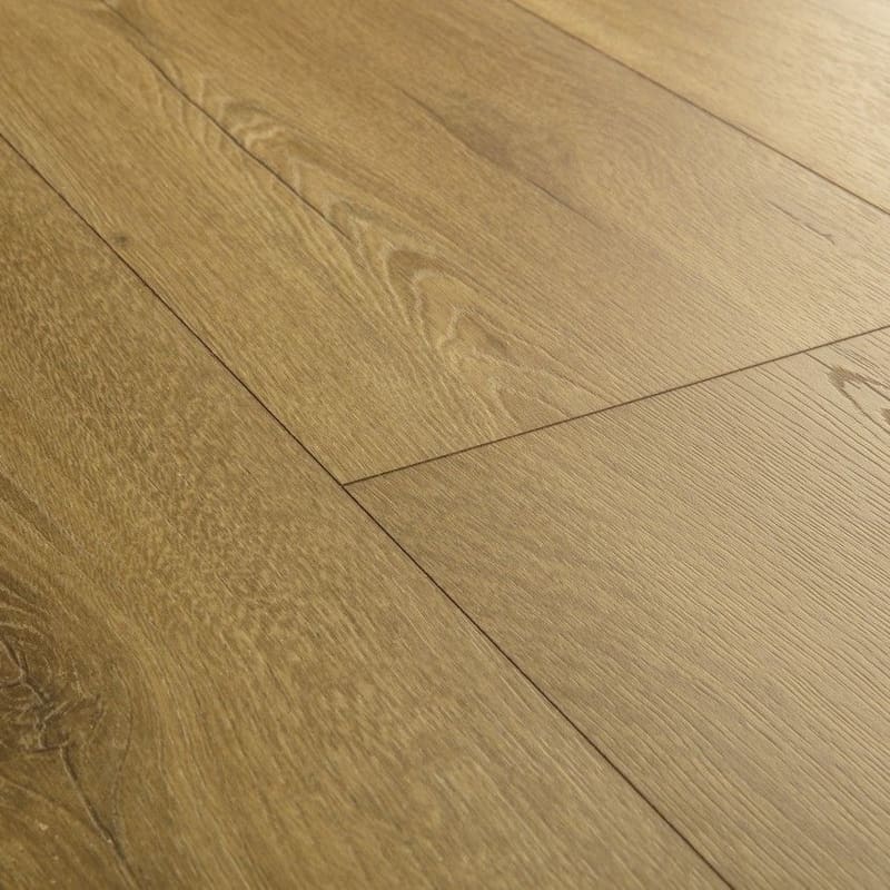 Close-up detail of honey oak laminate flooring showing grain pattern