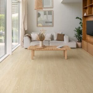 Quick-Step Frosty Beige Oak laminate flooring installed in a bright contemporary space with furniture