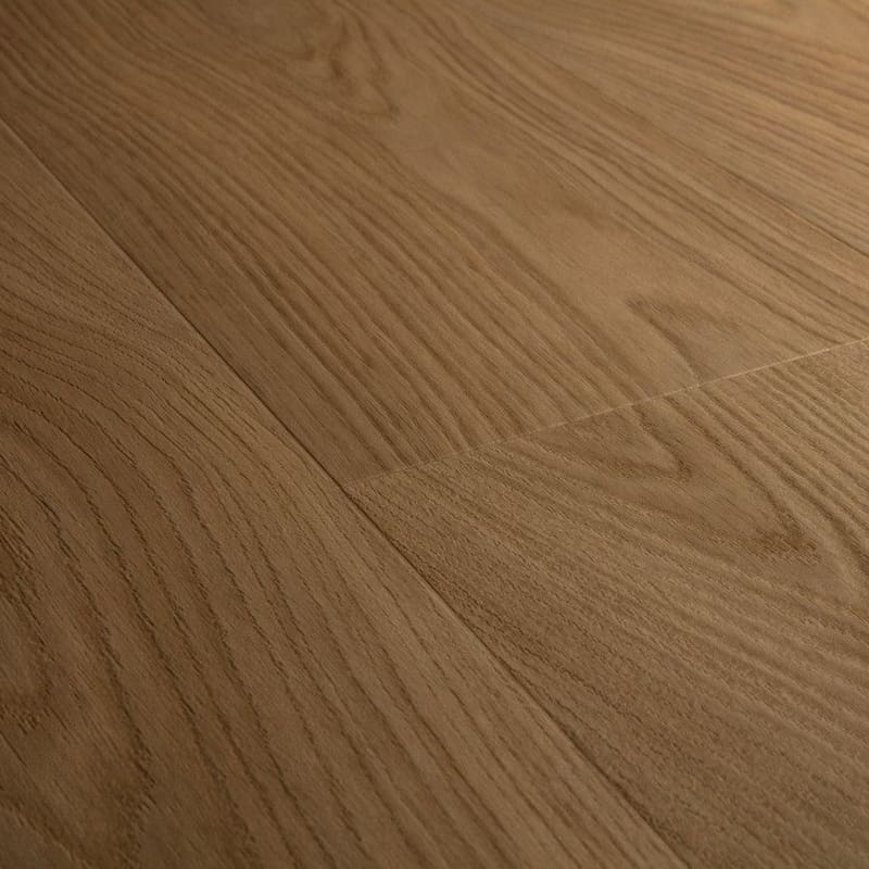 Close-up of Quick-Step Cocoa Oak vinyl flooring showing natural wood grain texture and warm brown tones