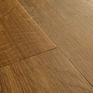 Close-up of Quick-Step Alpha Bloom Amber Oak flooring showing detailed wood grain texture and warm amber tones