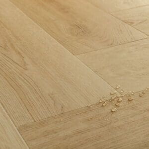 Detail view of Quick-Step Alpha Ciro Botanic Beige Herringbone showing wood grain texture
