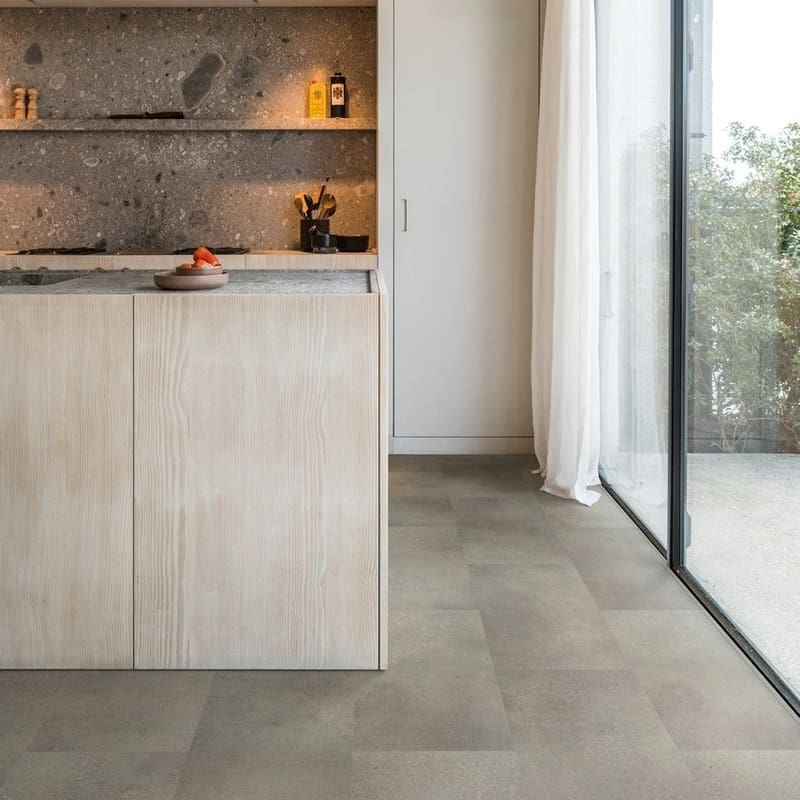 Modern kitchen with light wood cabinetry and Quick-Step Alpha Oro Concrete Rock flooring