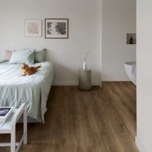 Close-up of Quick-Step Warm Brown Oak laminate flooring showing natural wood grain texture