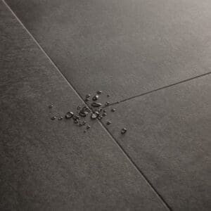 Quick-Step Soft Graphite vinyl flooring in a minimalist bedroom setting